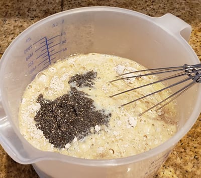Milk, eggs and chia seeds added to the dry ingredients and stirred with a wire whisk.