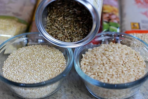 Three bowls with healthy whole grains are good ingredients in a healthy south Asian diet