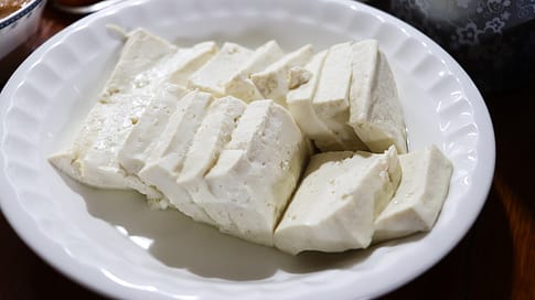 Sliced tofu on a plate. Tofu is a good vegetarian protein option